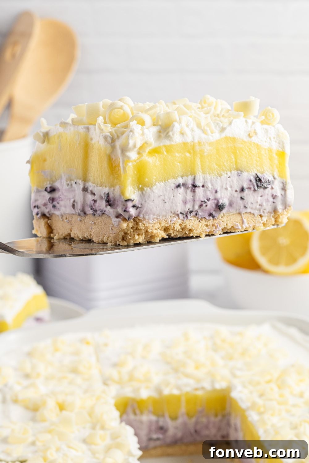 A perfectly formed piece of lush dessert being lifted out of the pan, demonstrating the firm set of the layers.