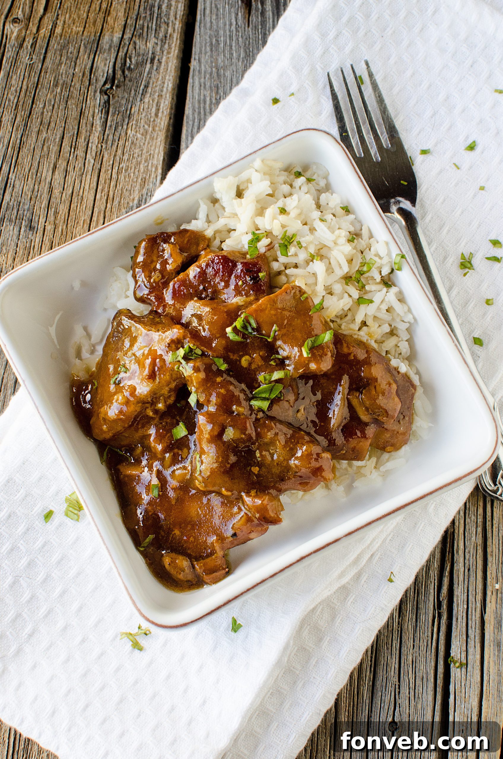 Tender Garlic Ginger Slow Cooker Pork 12 Close-up of a portion of slow-cooked pork, showcasing its tenderness and glaze.
