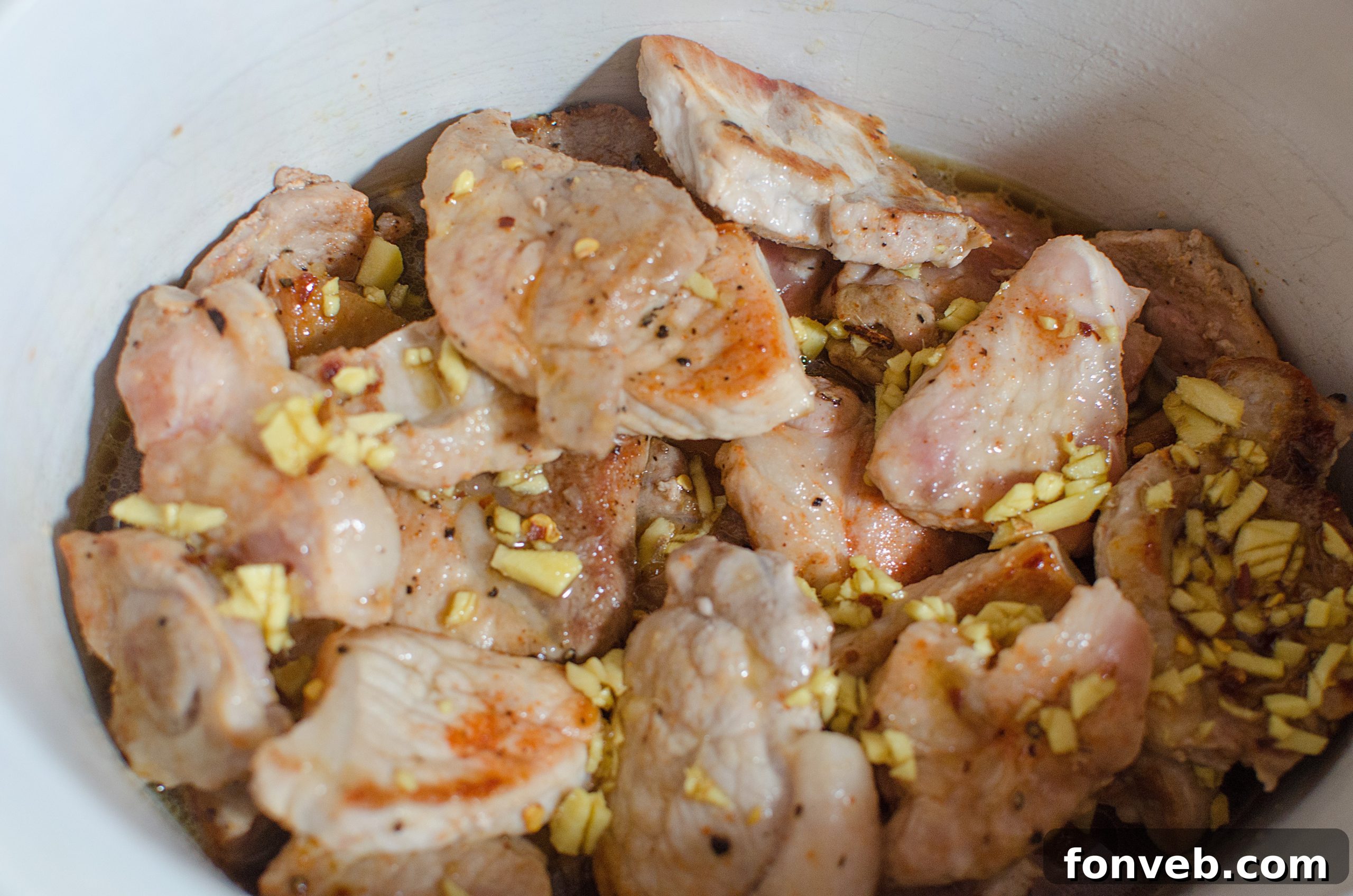Tender Garlic Ginger Slow Cooker Pork 4 Seared pork transferred to a slow cooker, ready for the sauce.