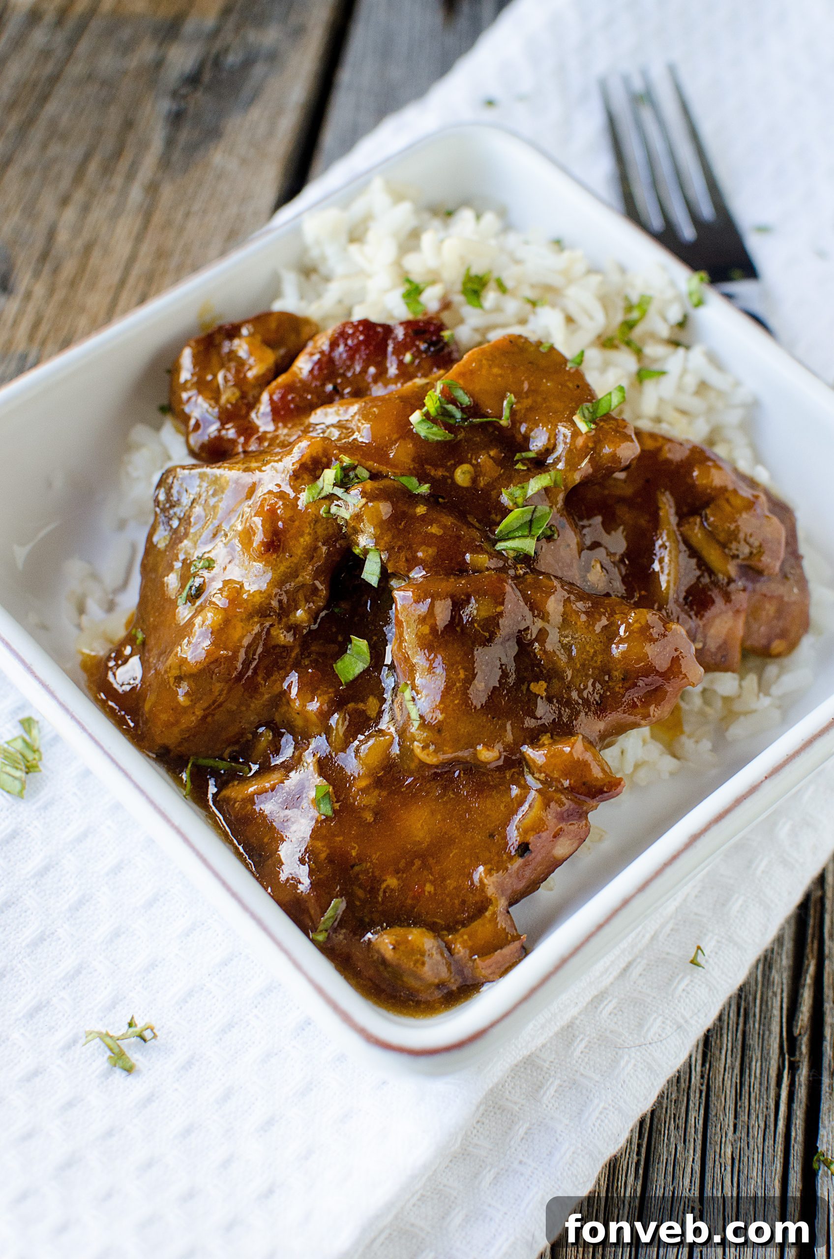 Tender Garlic Ginger Slow Cooker Pork 8 Serving suggestion: Slow Cooker Garlic Ginger Pork garnished with fresh herbs.