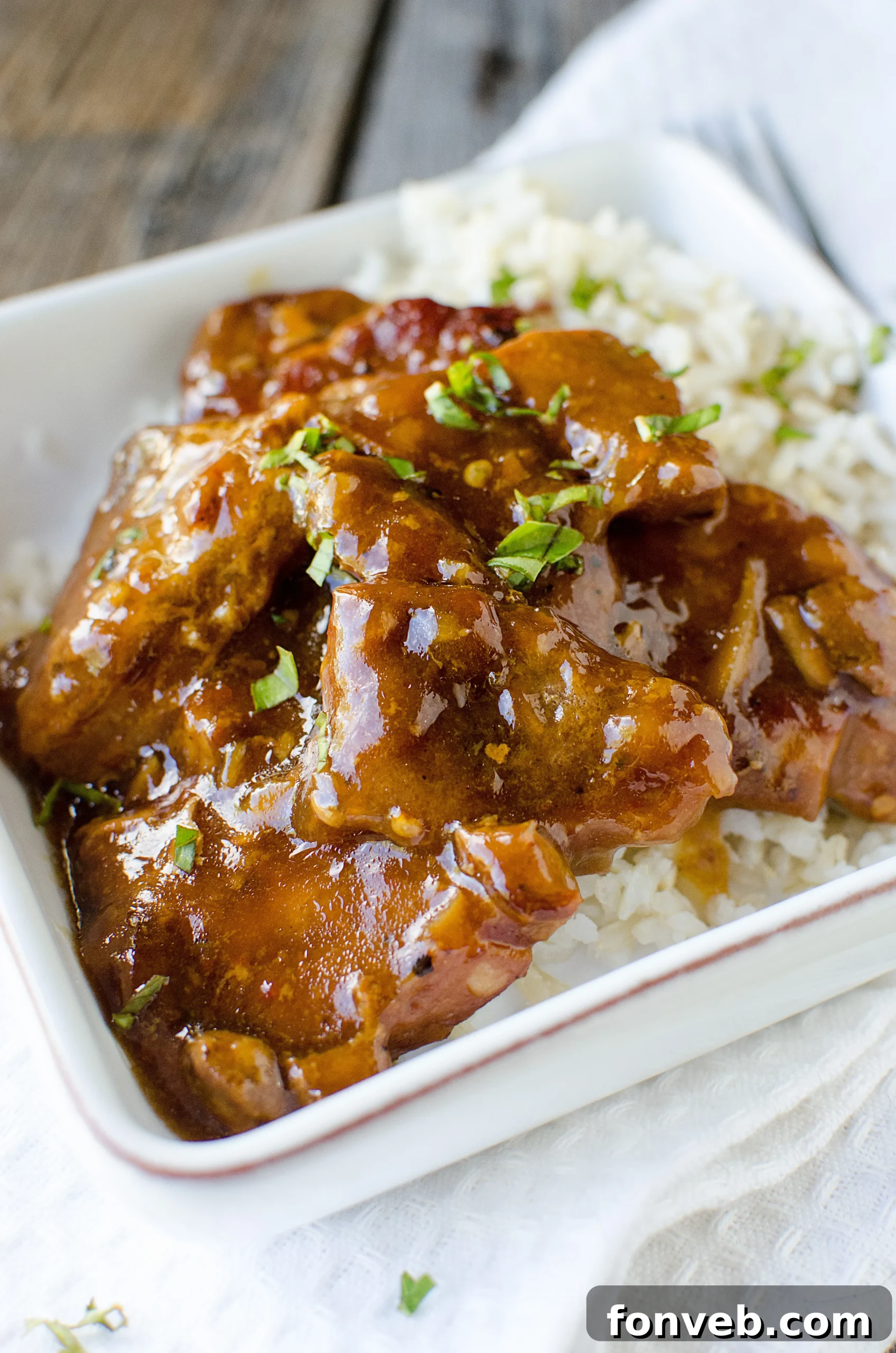 Tender Garlic Ginger Slow Cooker Pork 9 Close-up of the rich, thick honey-garlic-ginger sauce coating the tender pork.
