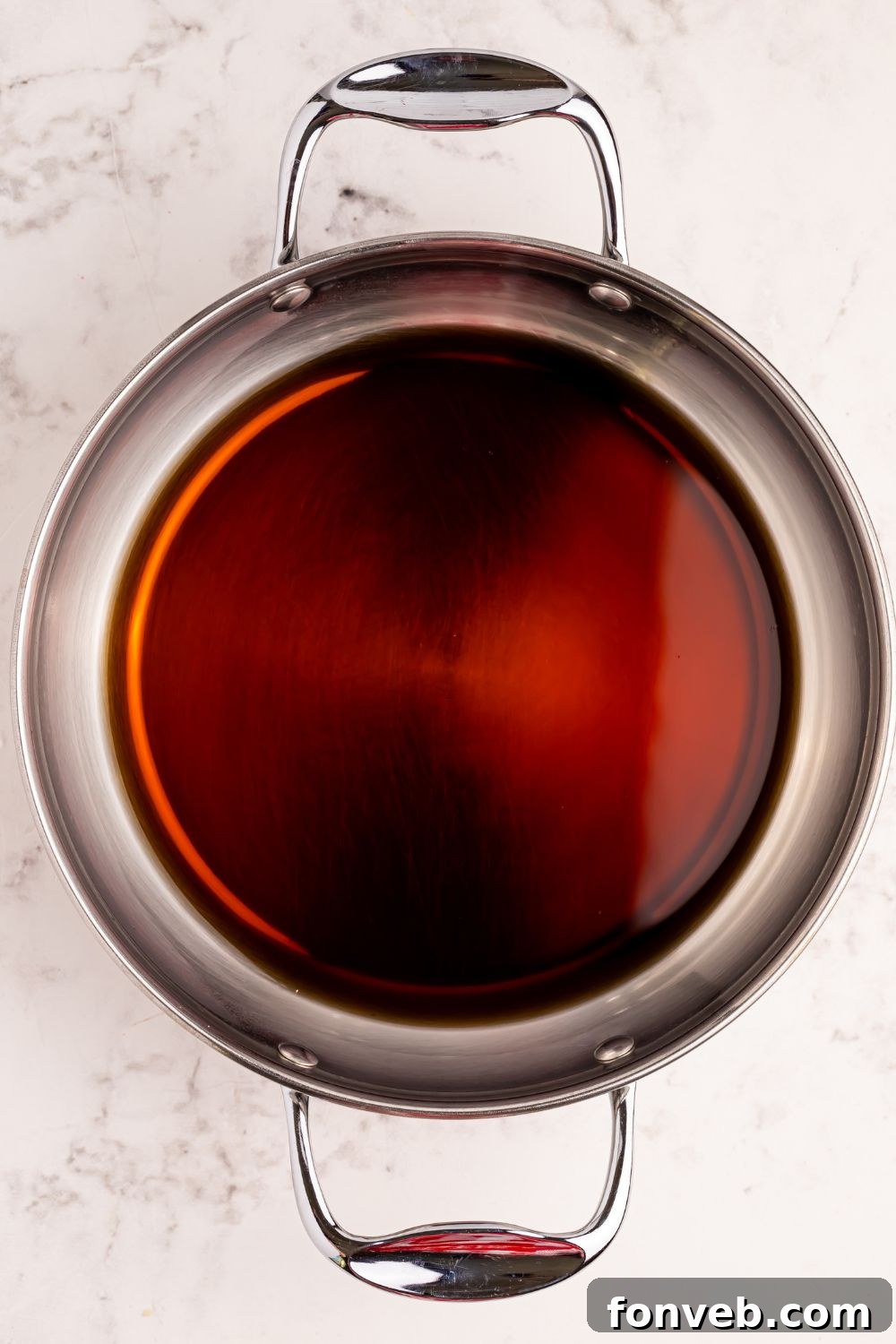 Classic Dr. Pepper Cake 8 A can of Dr. Pepper placed on a metal baking pan on a rustic wooden table, symbolizing the key ingredient for the cake.