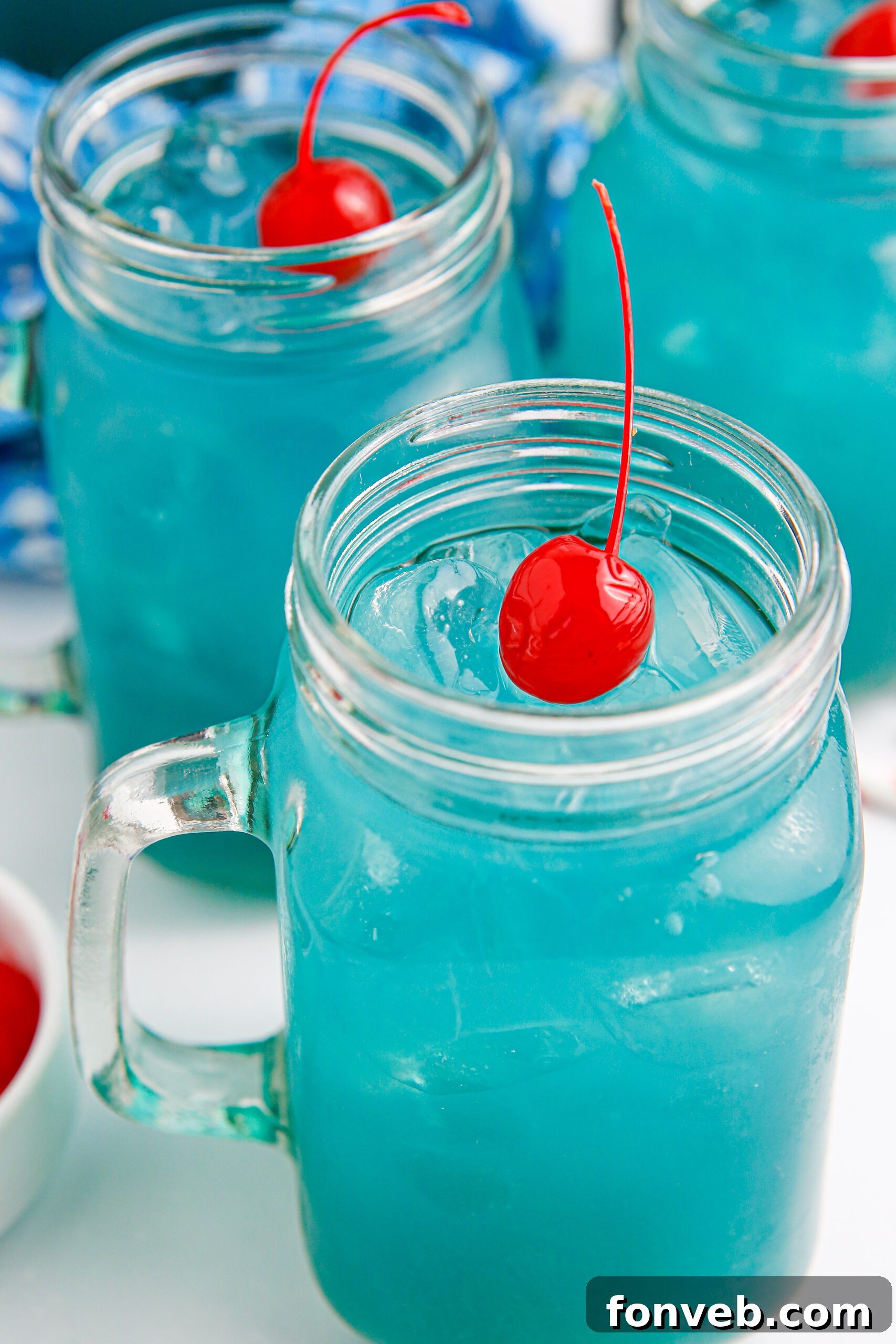 Close-up shot of the stunning blue hue of the Hawaiian Punch, ready to be served in elegant glasses.