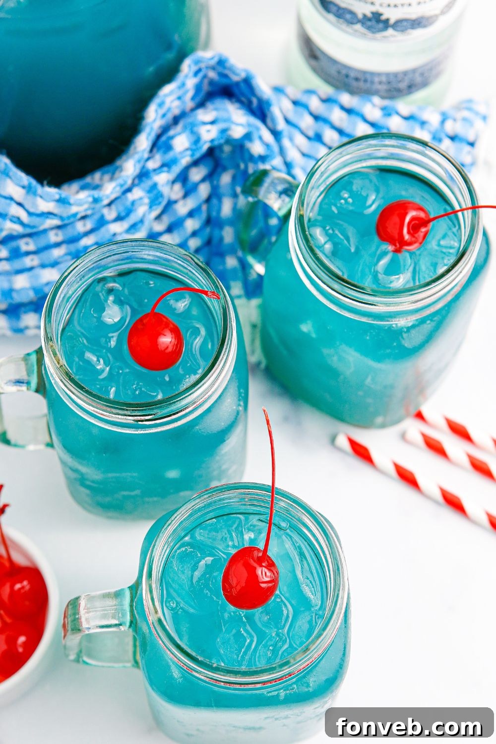 A glass of Blue Hawaiian Punch adorned with a cherry, showcasing its inviting appearance.