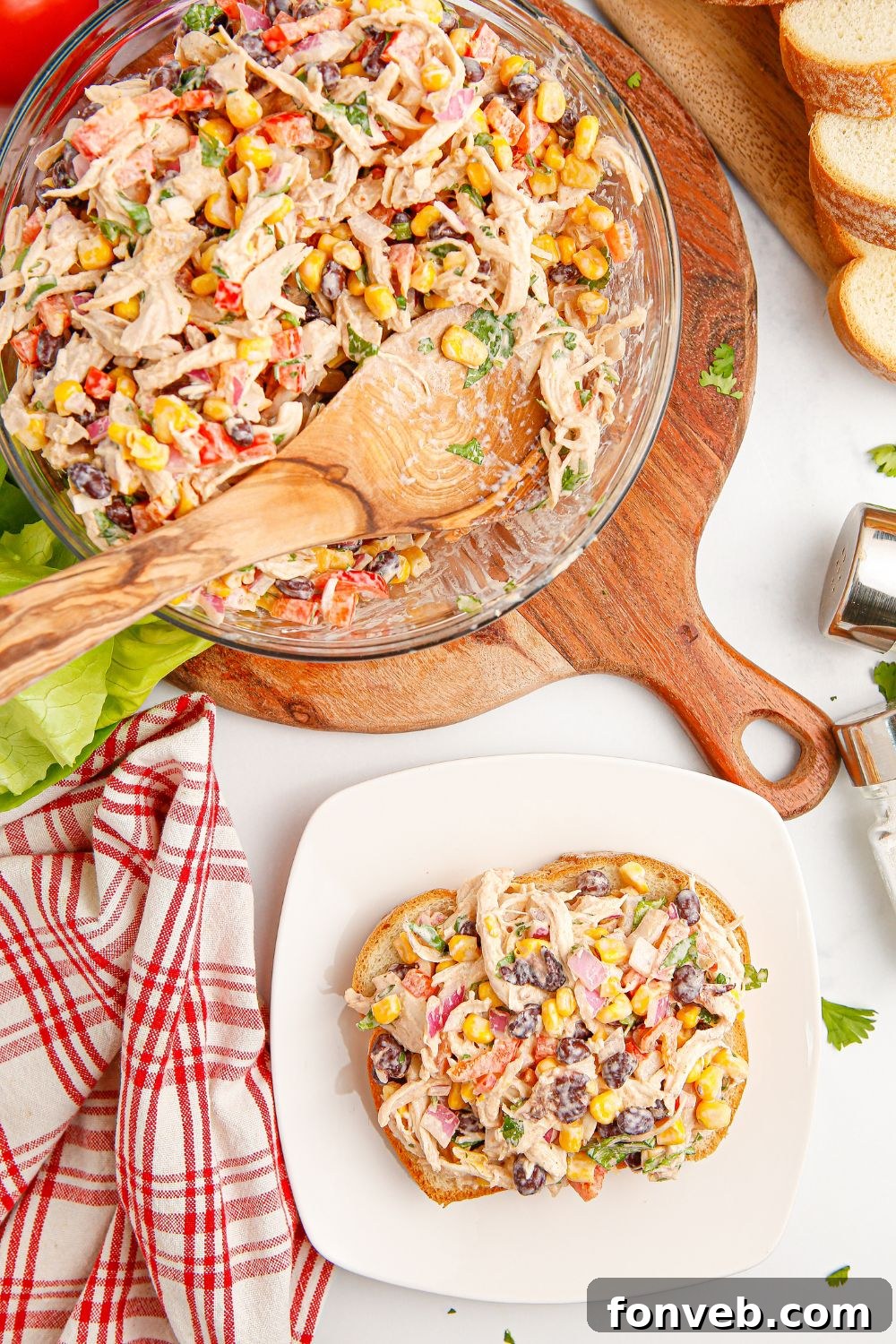 Southwestern Chicken Salad 12 A visually appealing shot of Southwest Chicken Salad, with a hearty portion on a slice of bread on a plate, and a larger bowl of the salad sitting behind it, suggesting a delightful meal.