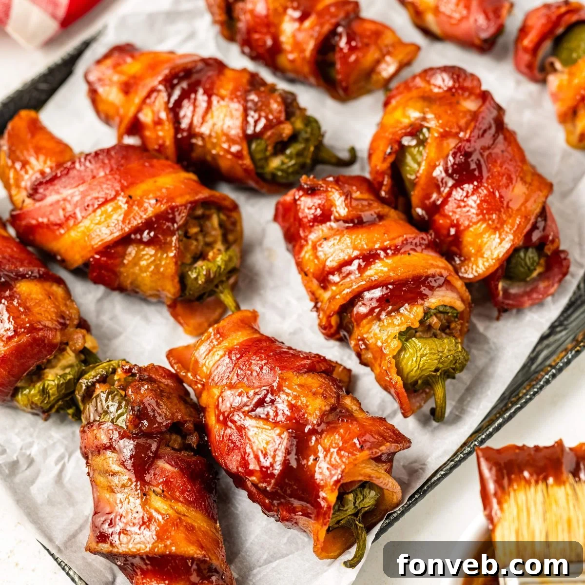 Texas Twinkies on a baking sheet with a bbq brush sitting on the side