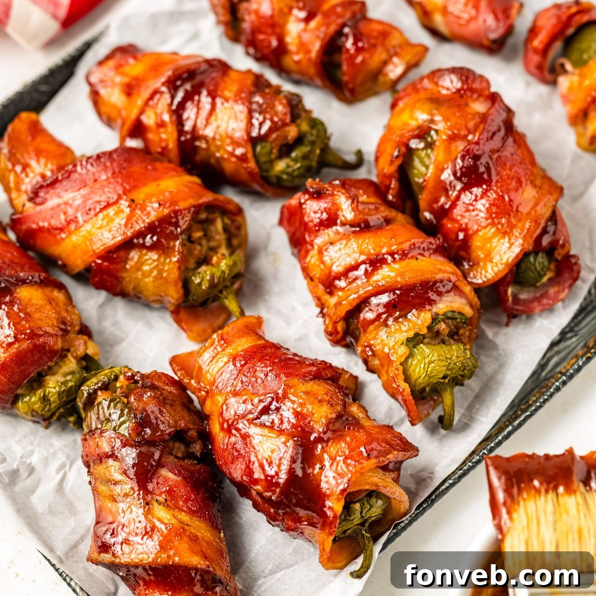 Texas Twinkies on a baking sheet with a bbq brush sitting on the side