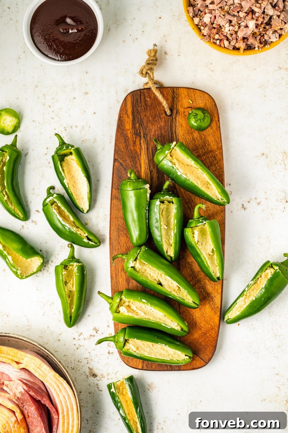 jalapeno peppers sliced aand placed on a wooden cutting board on table