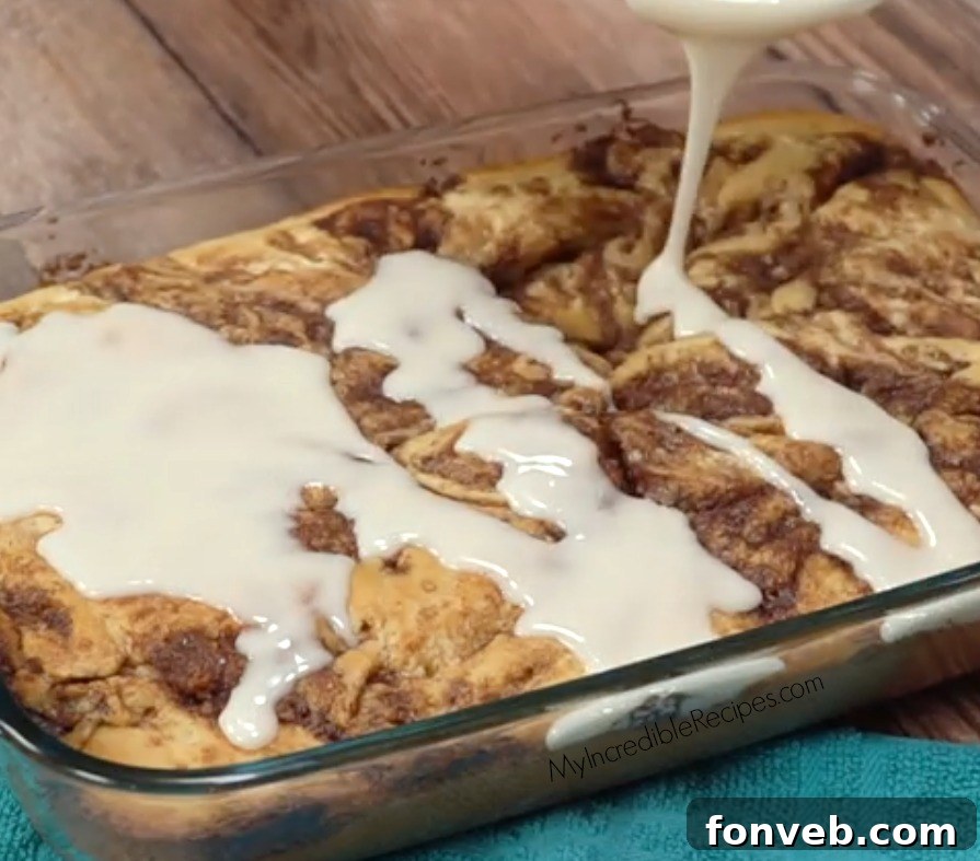 Irresistible Cinnamon Roll Cake 2 A perfectly baked homemade cinnamon roll cake, drizzled generously with sweet vanilla glaze, ready to be served.