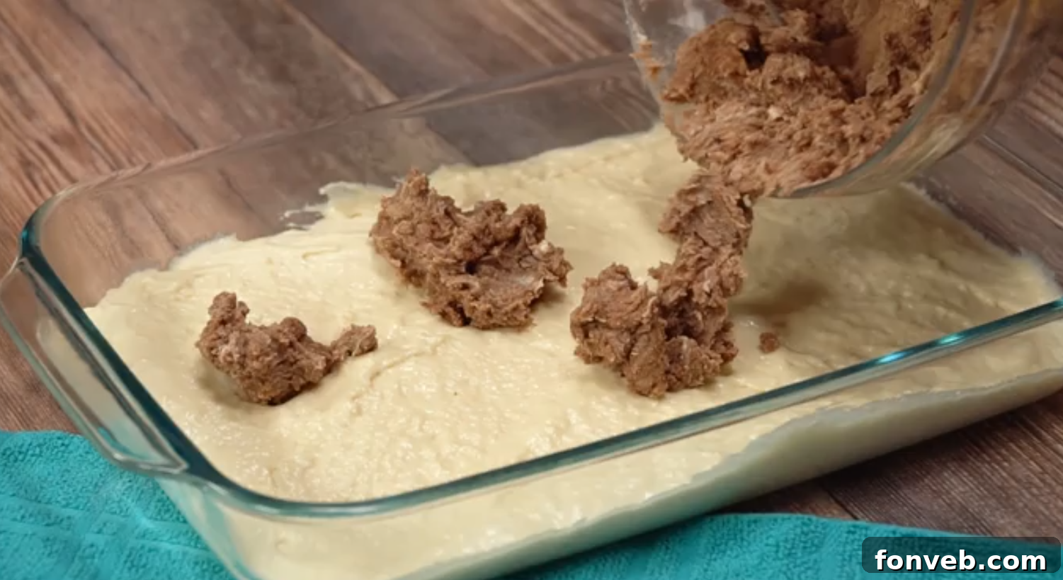 Irresistible Cinnamon Roll Cake 3 Close-up shot of the cinnamon swirl cake batter in a baking pan before going into the oven, showing the beautiful brown sugar and cinnamon swirls.