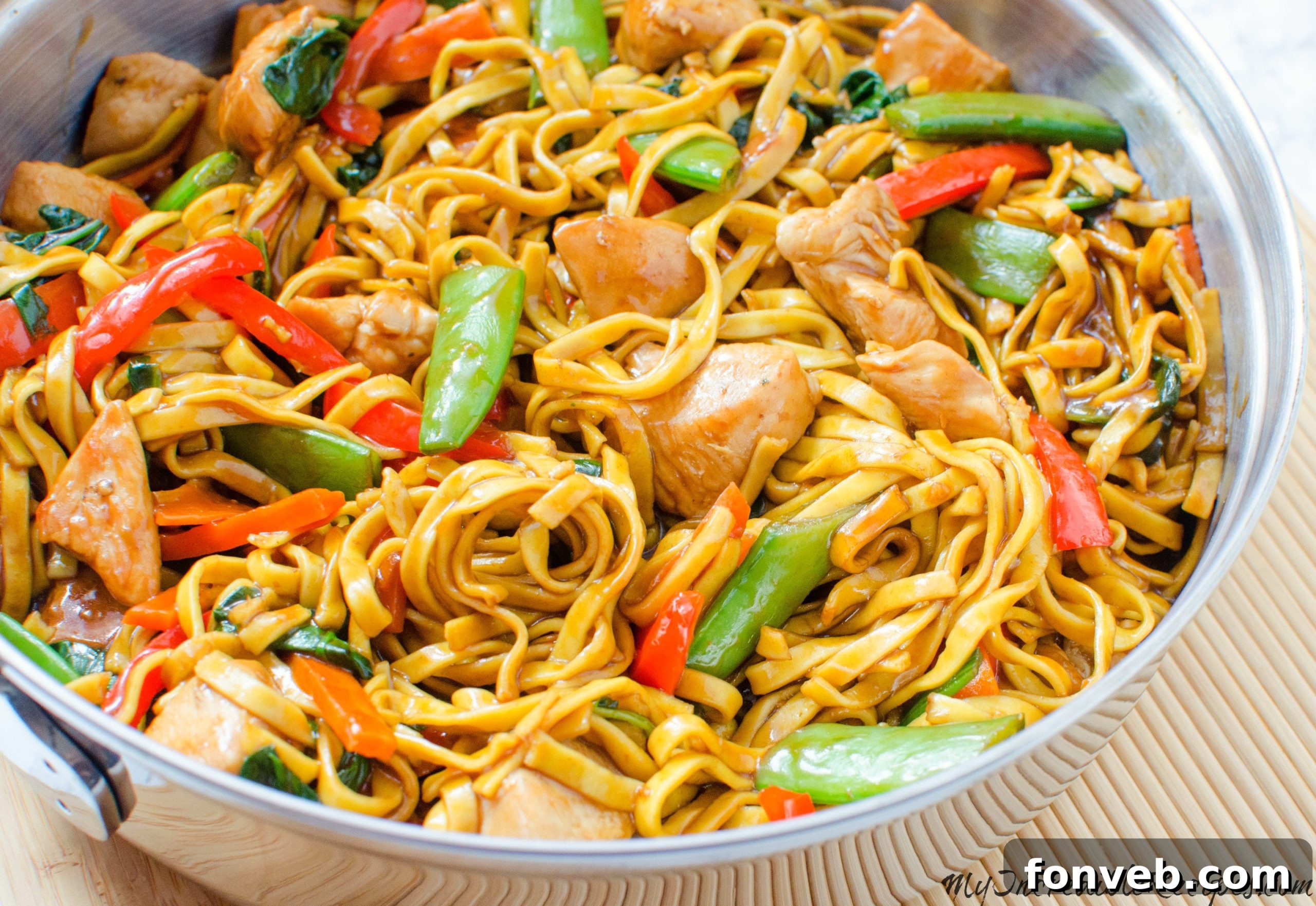 Homemade Chicken Lo Mein Better Than Takeout 6 Sizzling chicken being cooked in a large wok
