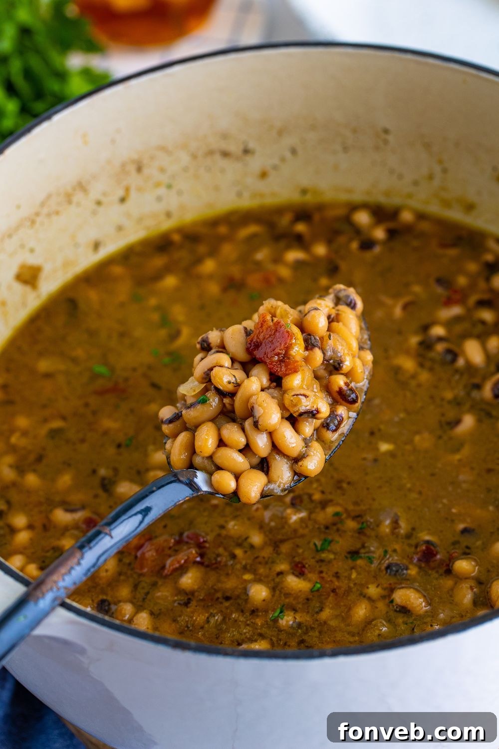 A simmering pot of black-eyed peas, filling the kitchen with a comforting aroma.