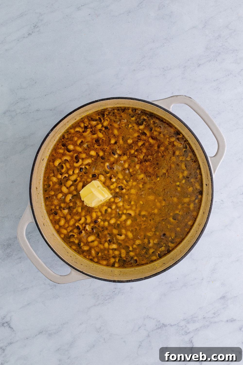 Black Eyed Peas with a slice of butter on the top of the peas 