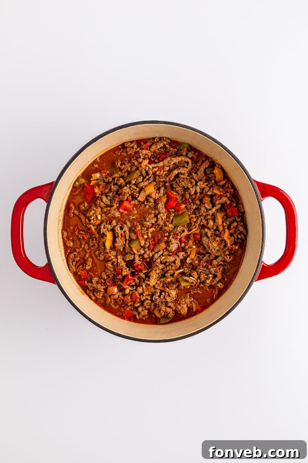 Zesty Ground Beef Medley 9 Overhead shot of Carne Picada simmering in a Dutch oven, showcasing the rich sauce and tender beef