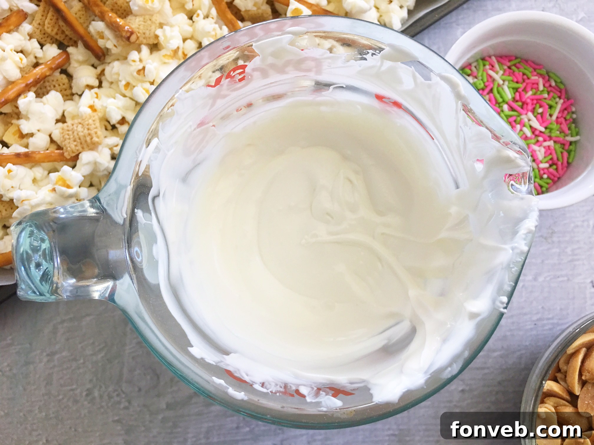 Bunny Bait Easter Crack ingredients, including a bowl of M&Ms, pretzels, and white candy melts