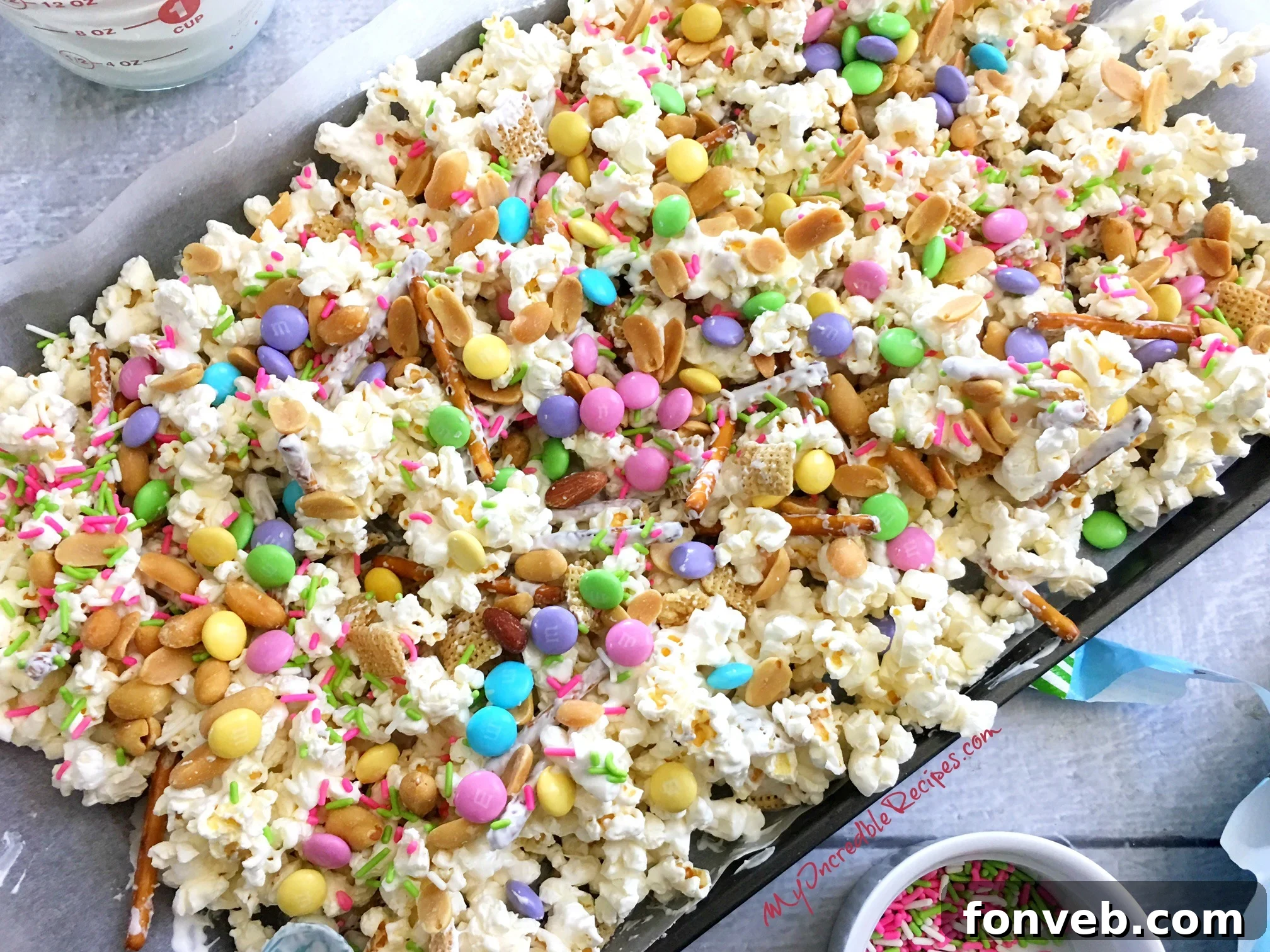 A bowl of finished Bunny Bait Easter Crack, colorful and ready to eat, with a decorative bunny in the background