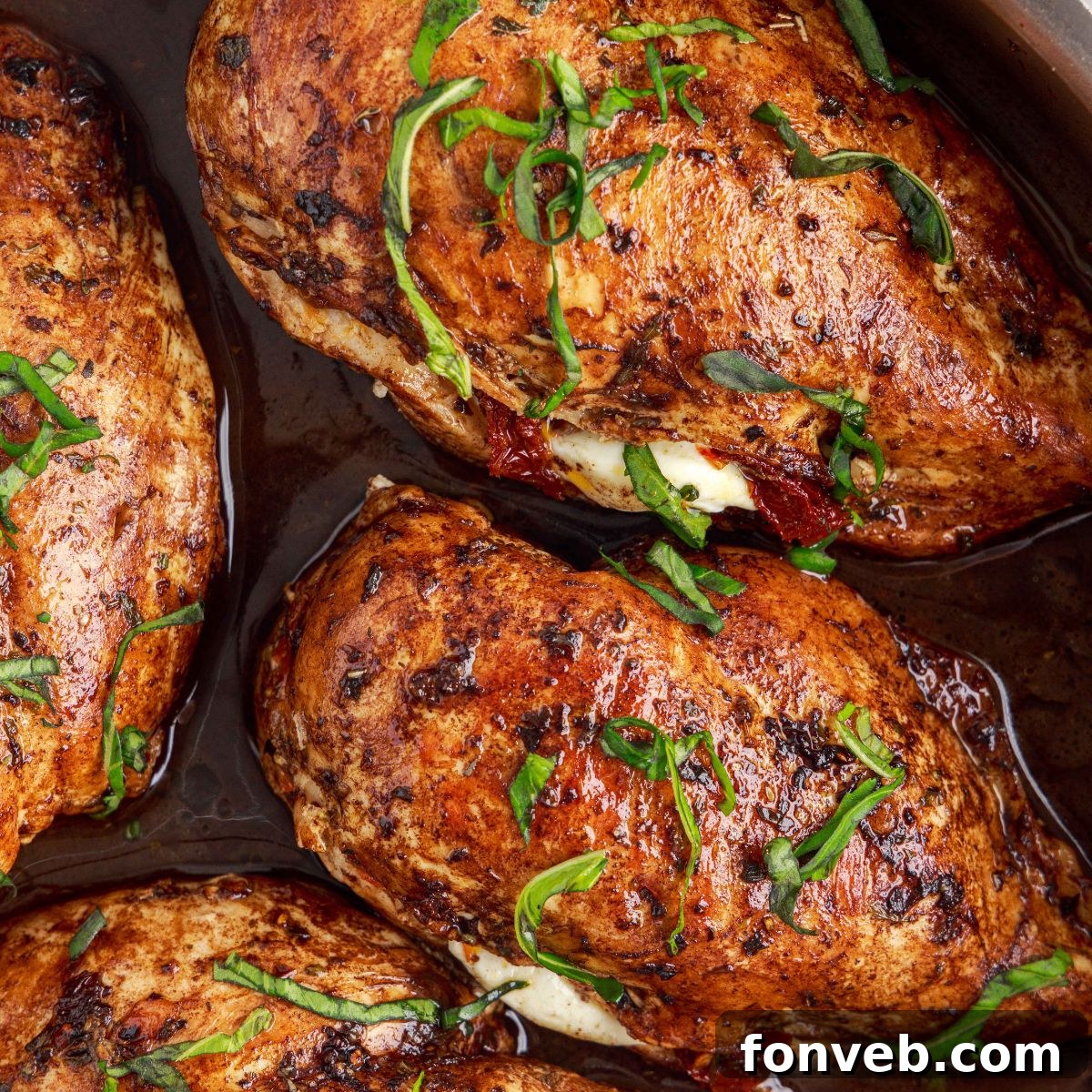 Caprese Stuffed Chicken in a skillet ready to be served, showcasing the melted cheese and fresh basil