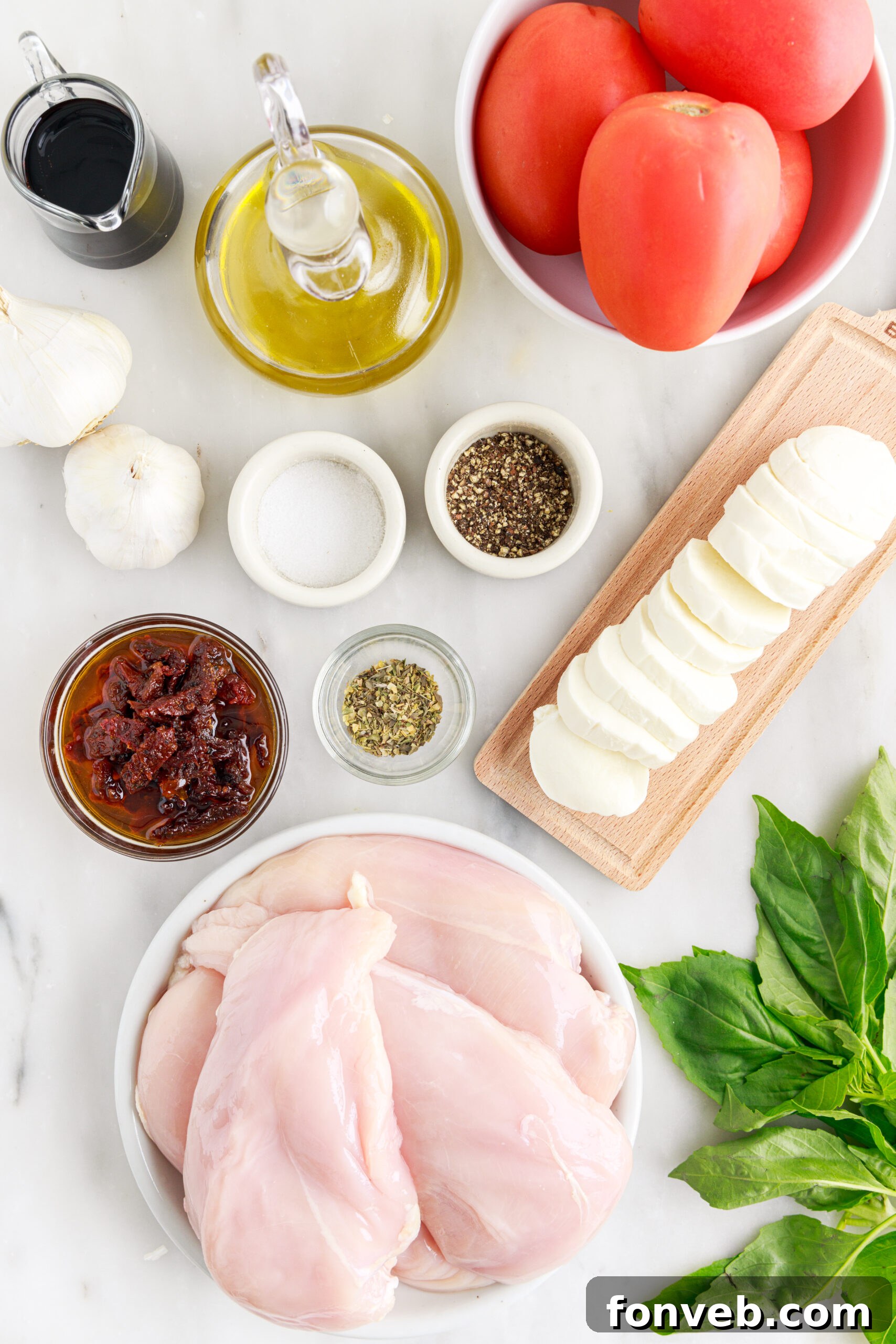 Caprese Stuffed Chicken ingredients sitting on a table in single-serve containers, neatly arranged to showcase each component