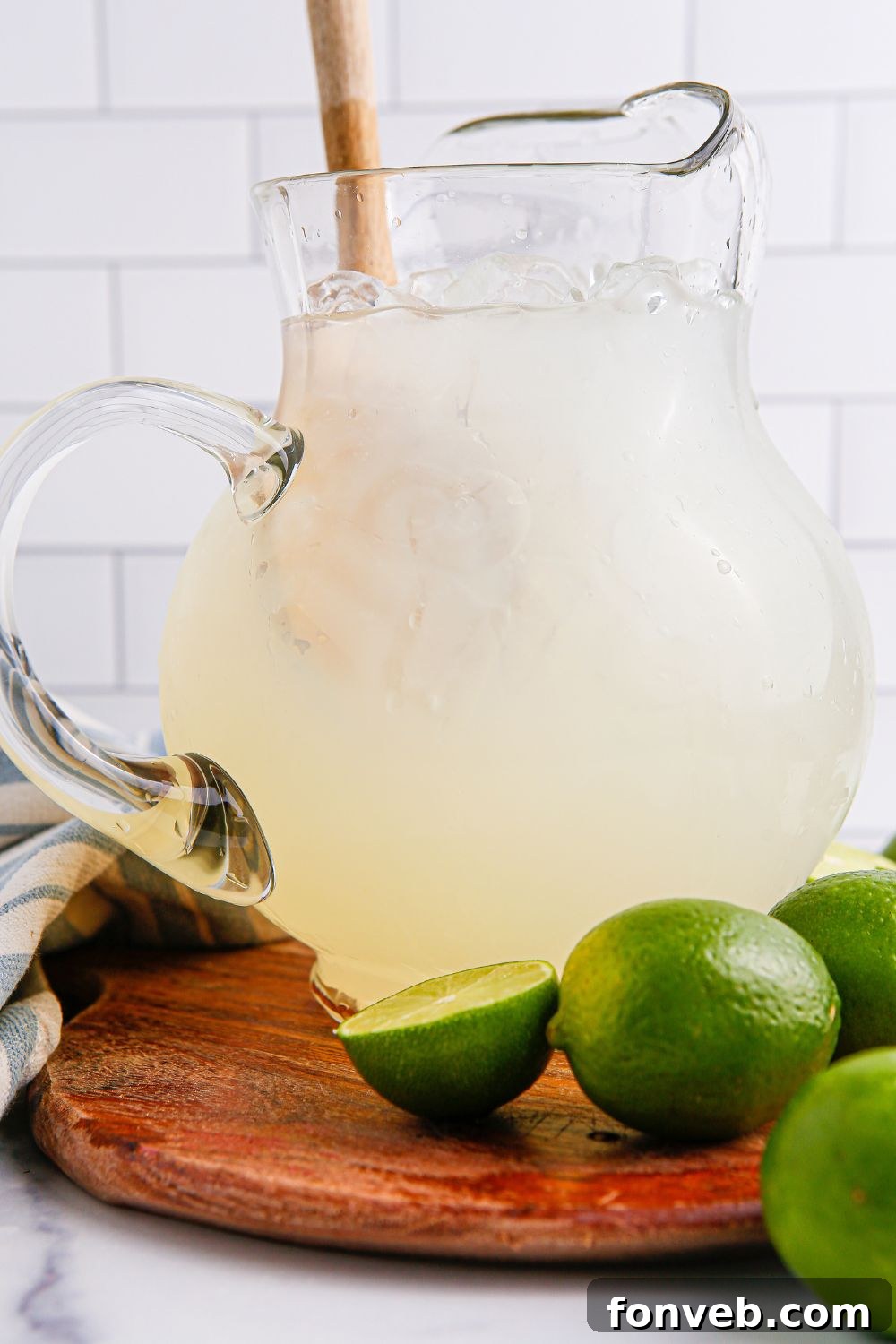 pitcher with limeade in it and a wooden spoon in pitcher