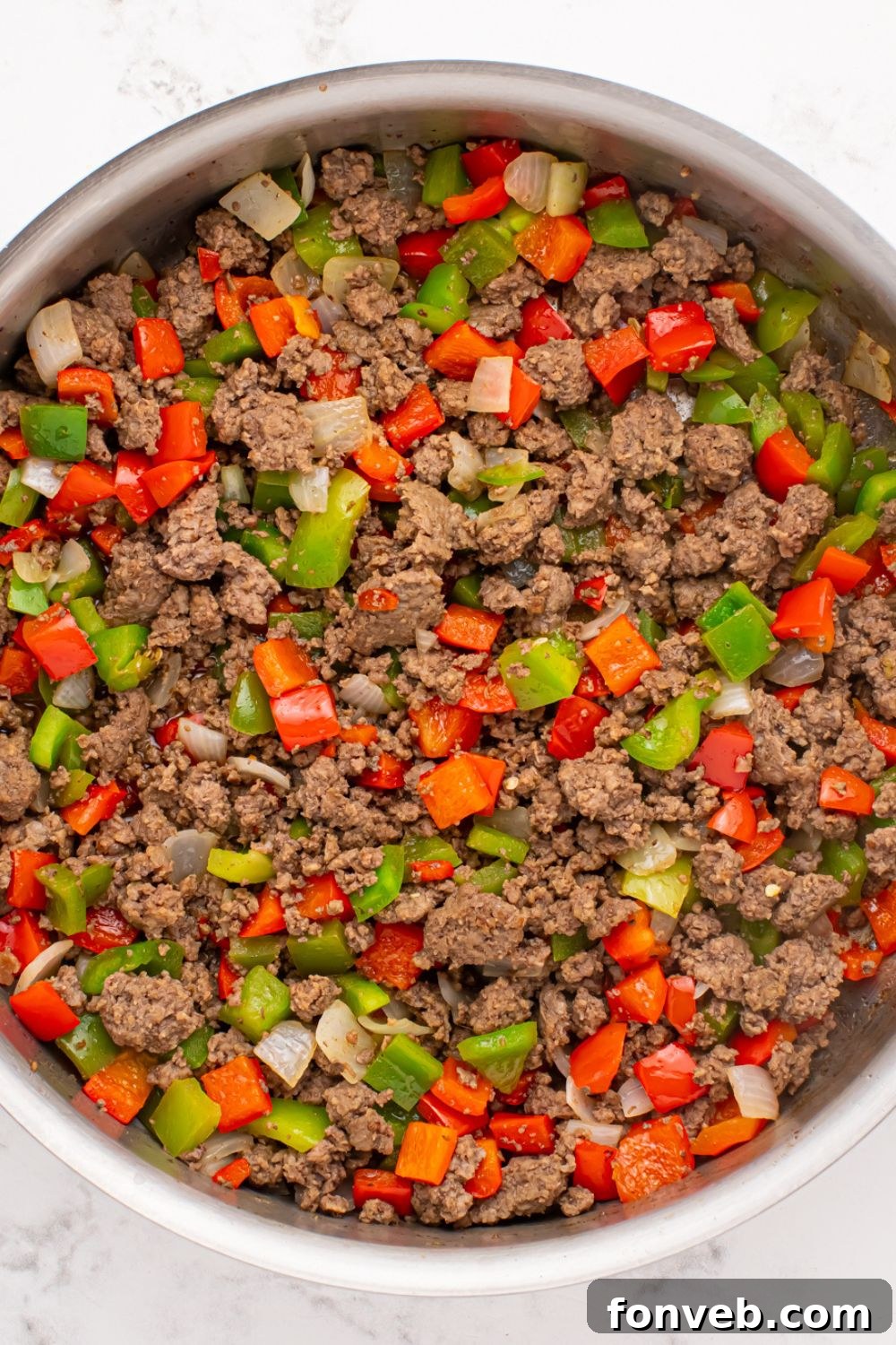 Creamy Philly Cheesesteak Pasta 6 ground beef, diced peppers and onions in a skillet