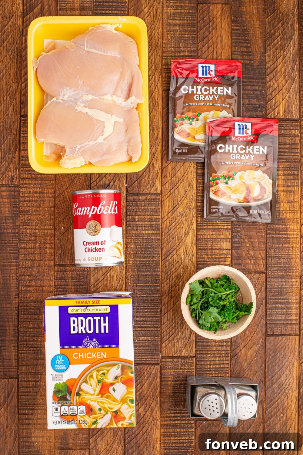ingredients for Crock Pot Chicken and Gravy items sitting on a wooden table 