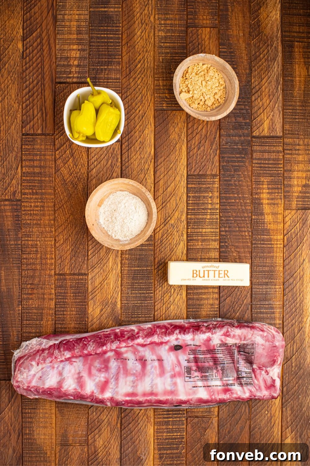 baby back ribs, stick of butter, and other ingredients in small bowls for the mississippi ribs recipe