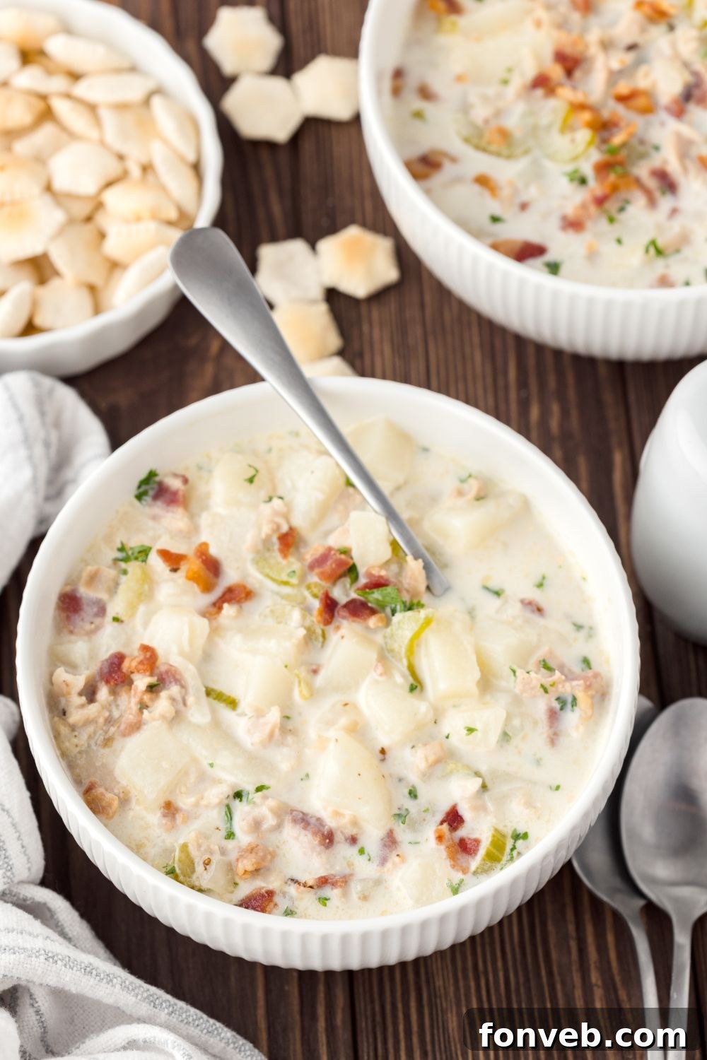 overhead look of table with clam chowder in bowls and a bowl of crackers