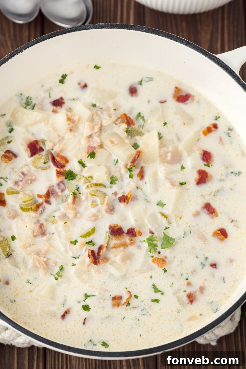 New England Clam Chowder in a large Dutch Oven sitting on table 