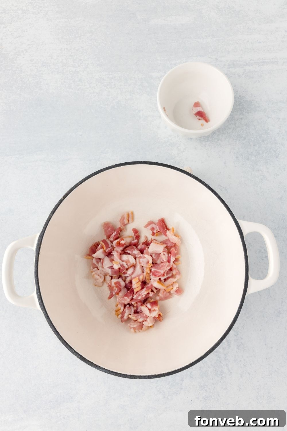 raw bacon in a stock pot sitting on table