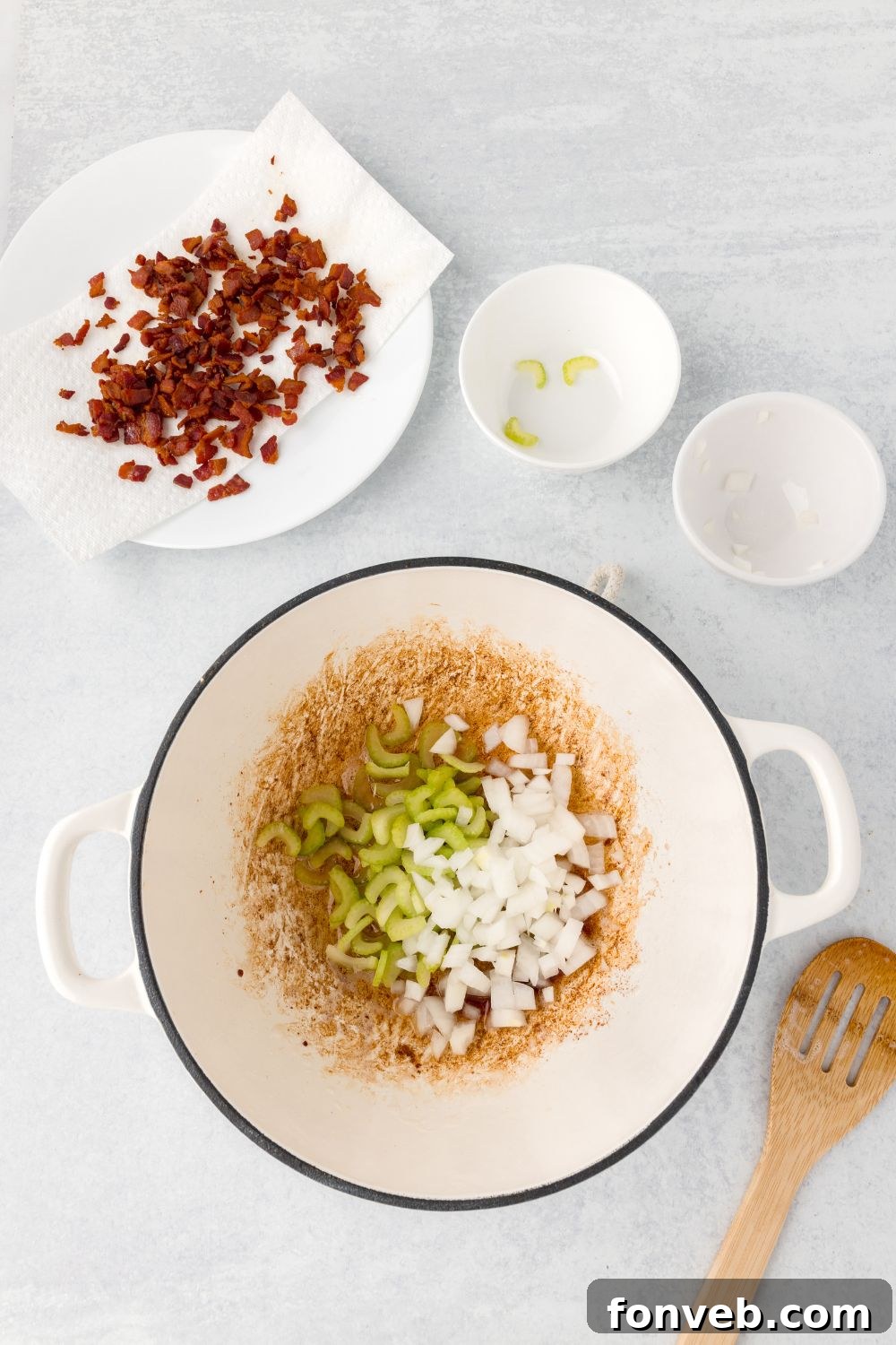 diced bacon, and onions and celery being sauted in a stockpot 