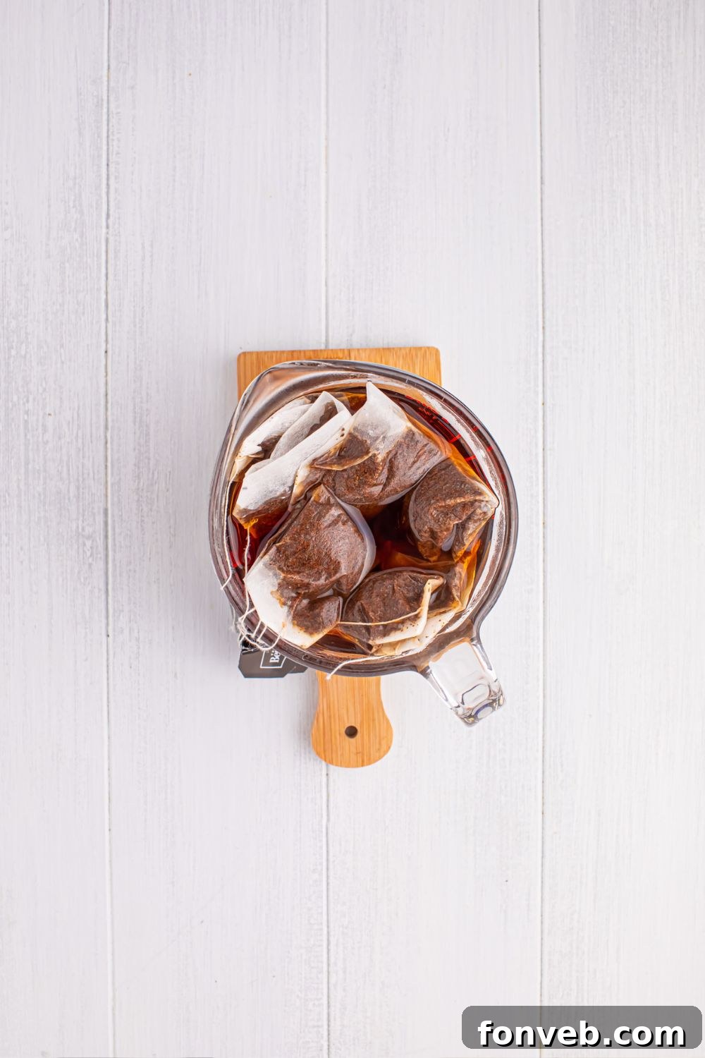 black tea steeping in a pitcher on table 