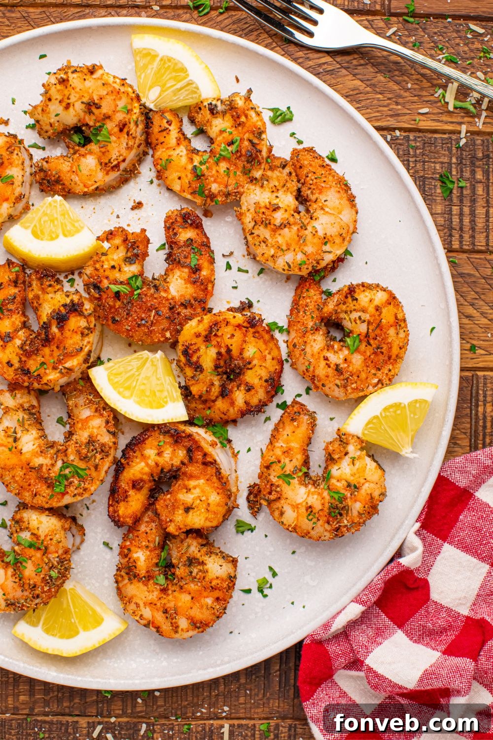 Cajun Grilled Shrimp on a plate showing the dry rub and lemon slices 