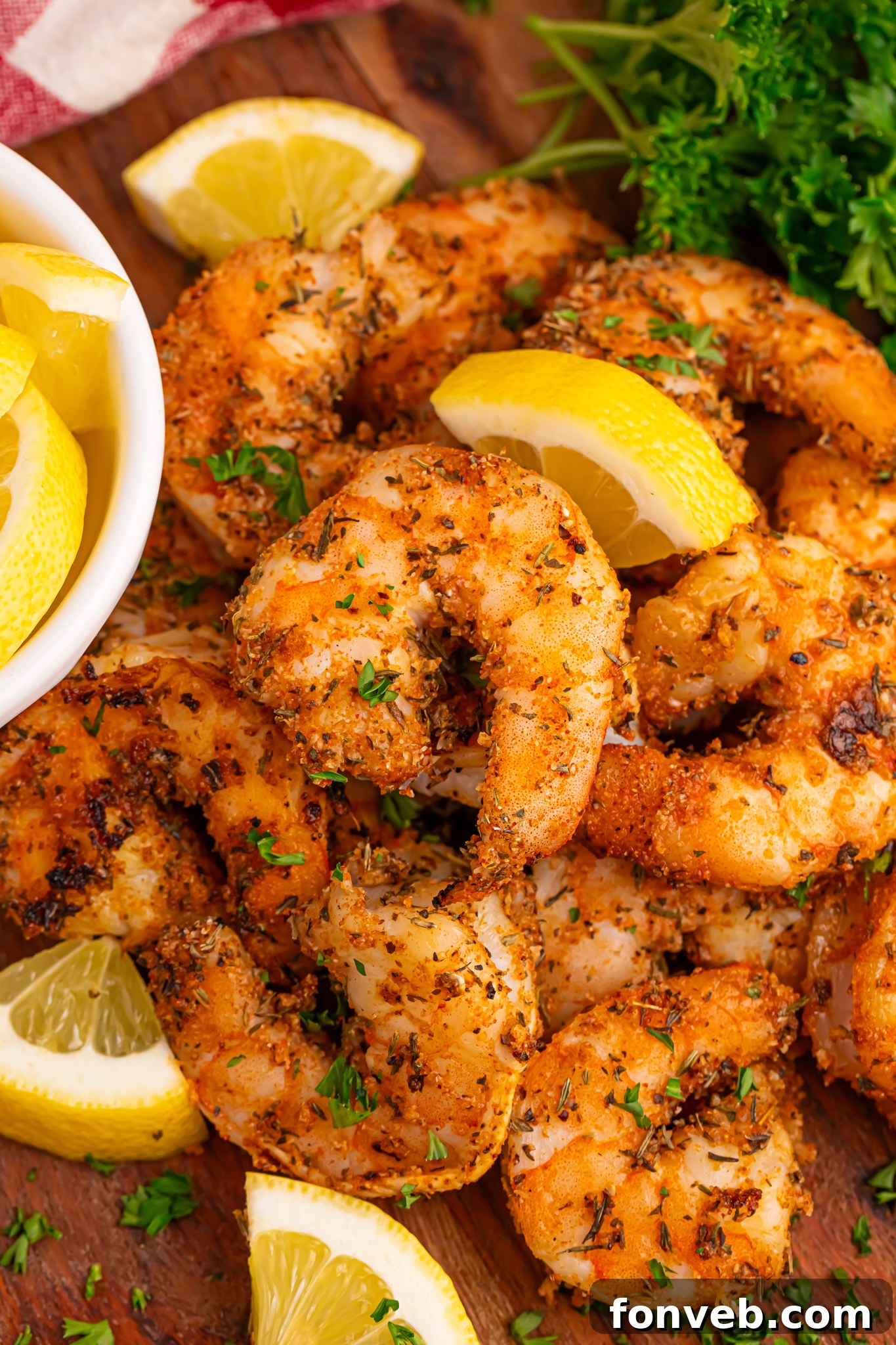 cajun shrimp piled with sliced lemons 
