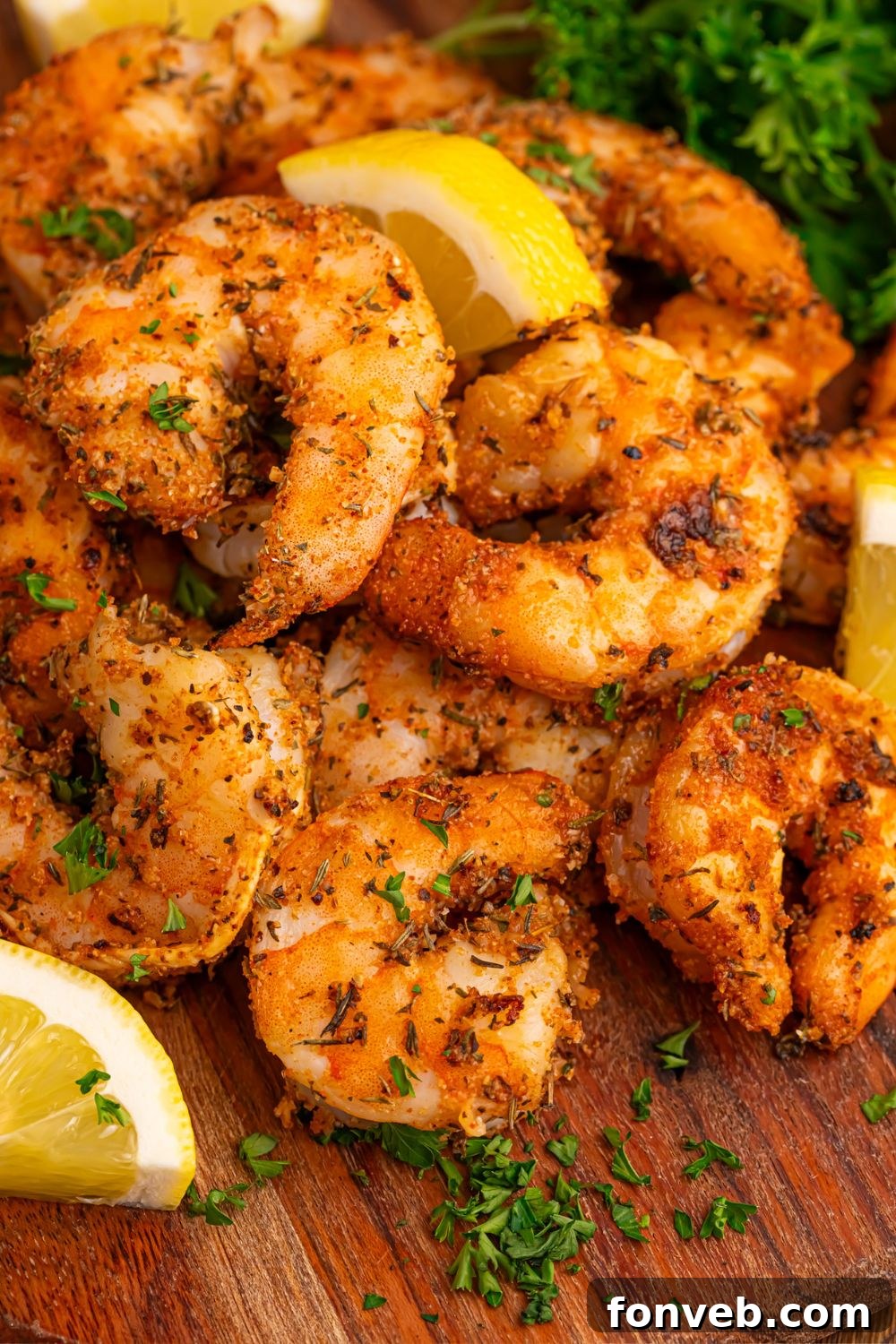 Cajun Grilled Shrimp on a cutting board with lemons on side