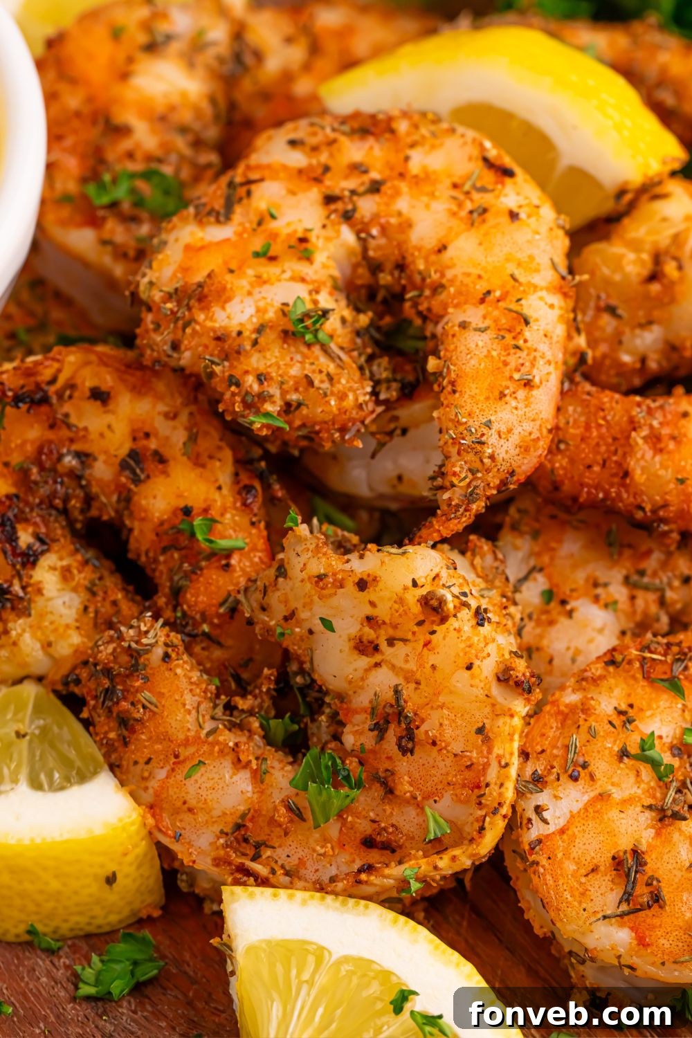 Cajun Grilled Shrimp on a plate with lemon wedges 