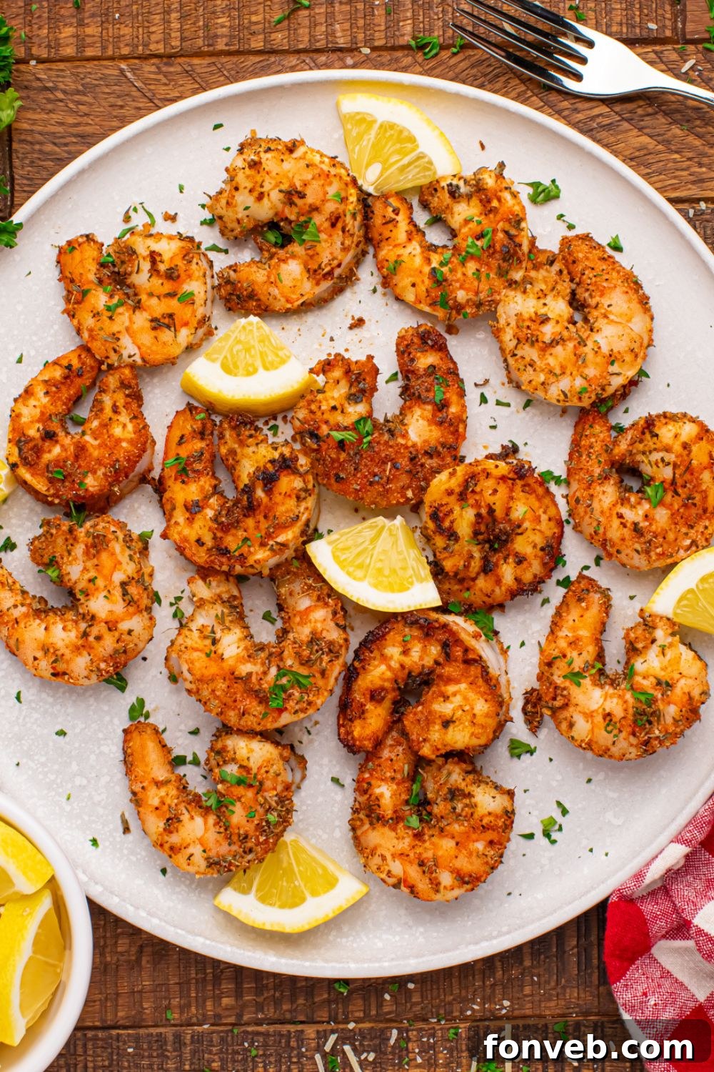 overhead shot of a plate on table with Cajun Grilled Shrimp scattered on it 