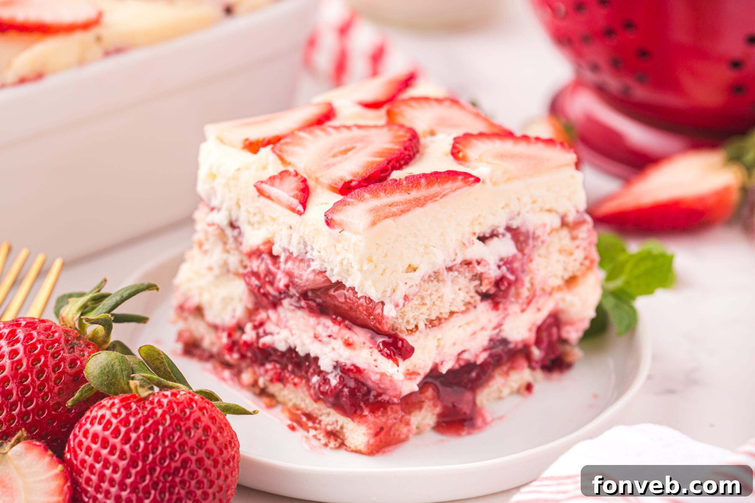A beautifully presented slice of Strawberry Tiramisu garnished with fresh strawberries