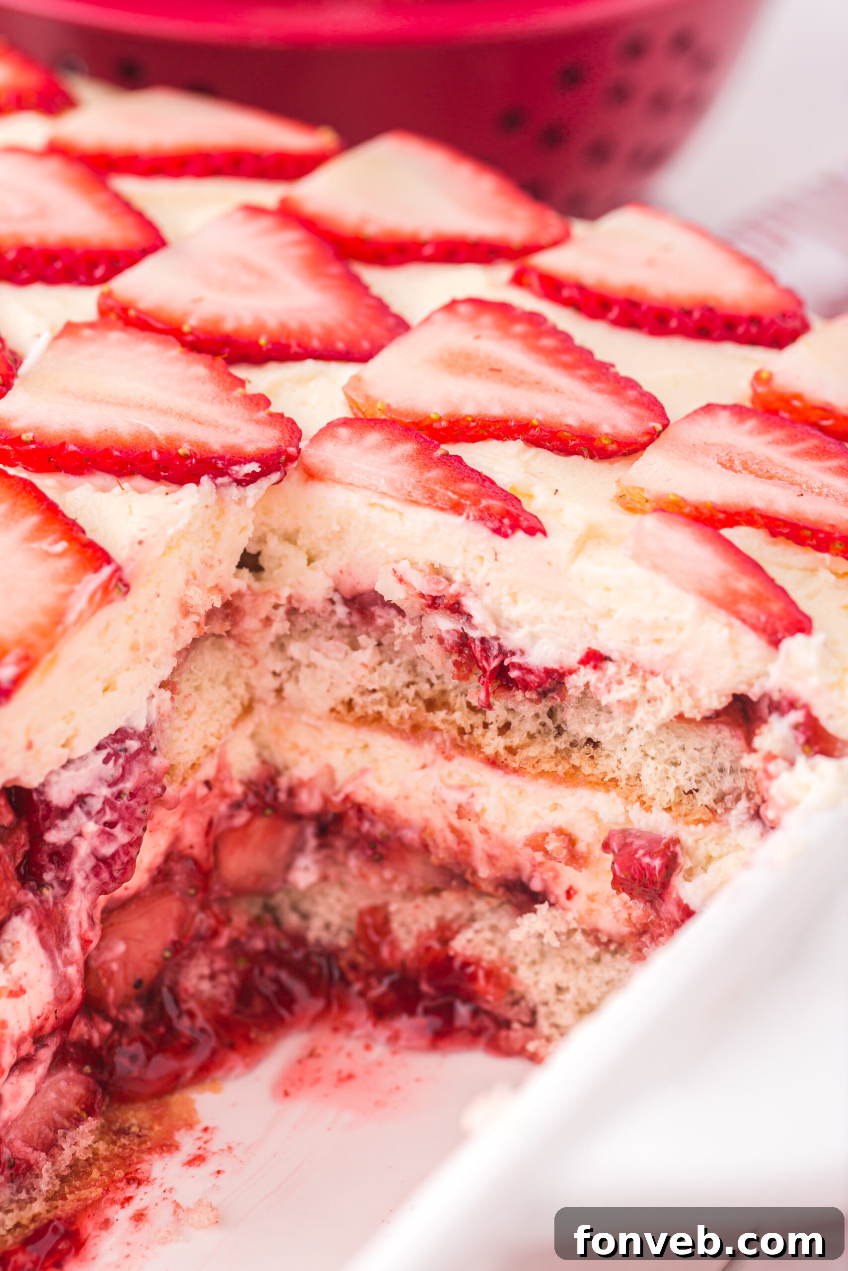 Strawberry Tiramisu in a white baking dish with a slice removed 
