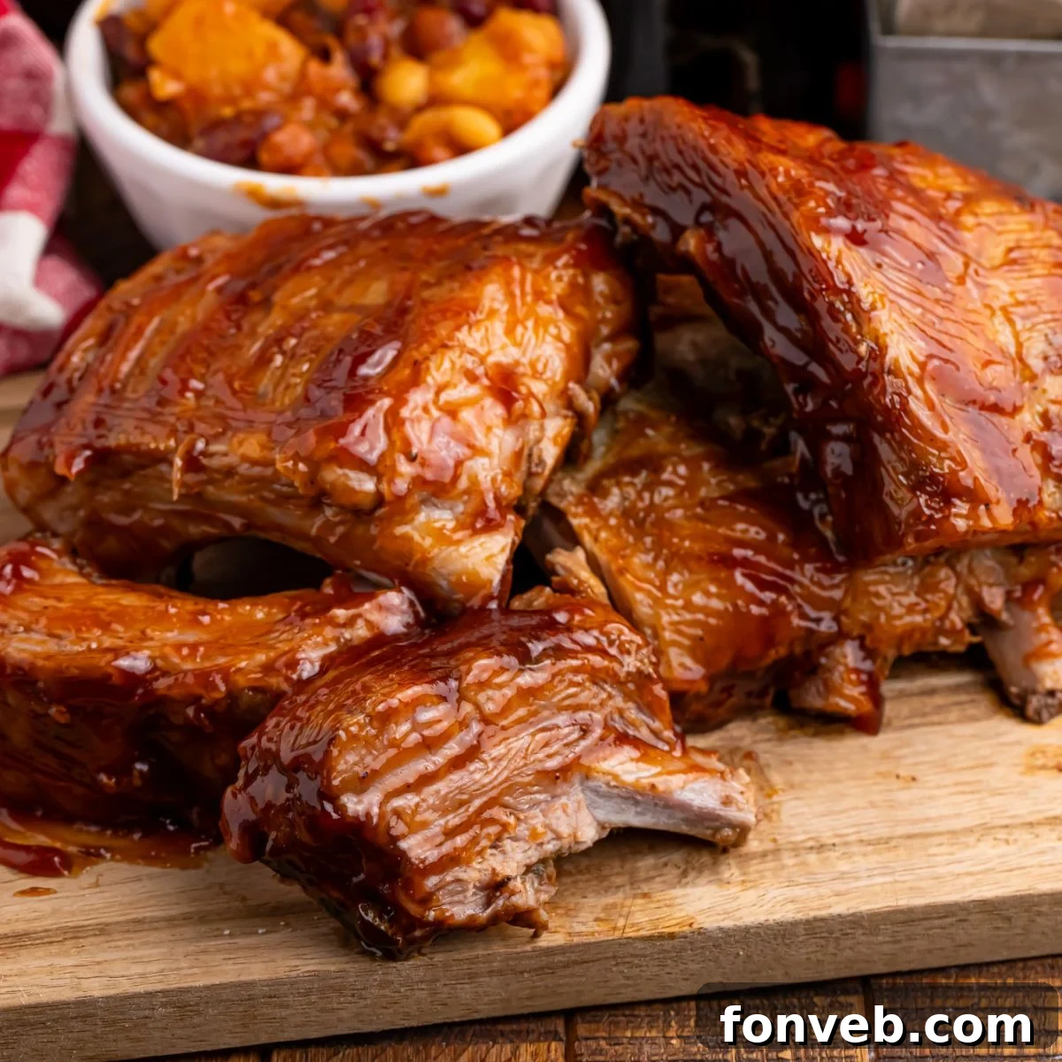 Tender Slow Cooker Coca Cola Ribs on a rustic wooden cutting board, garnished with fresh herbs