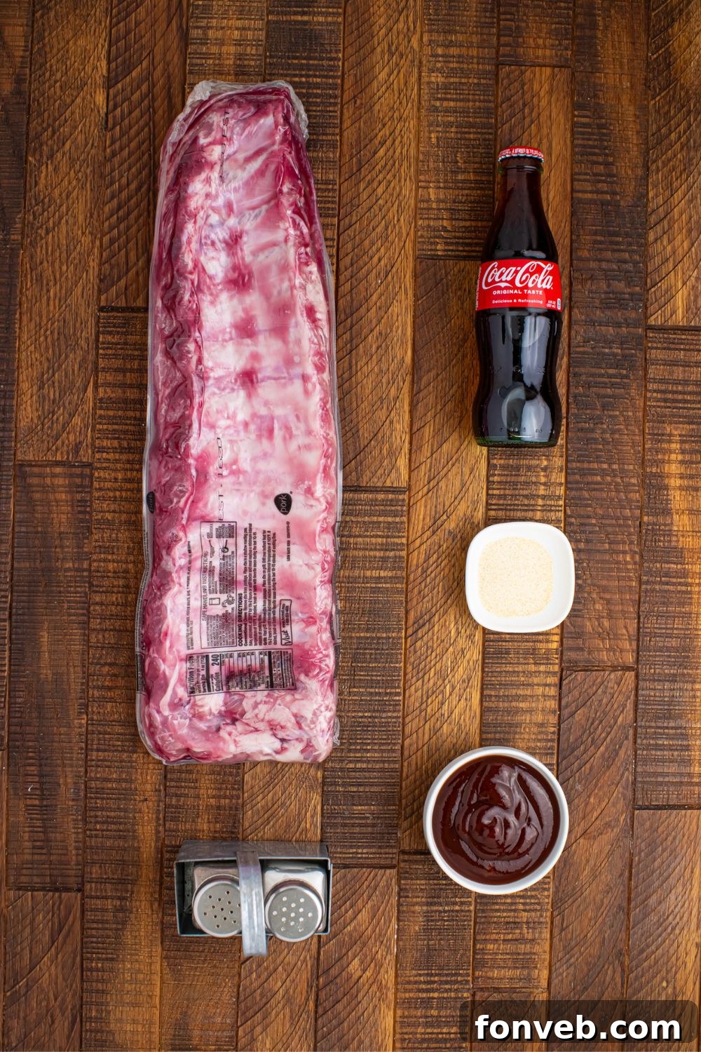 Fresh ingredients for Slow Cooker Coca Cola Ribs laid out on a wooden table