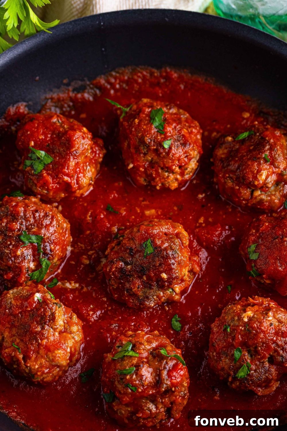 Classic Italian Meatballs in a sauce in a pan sitting on the counter 