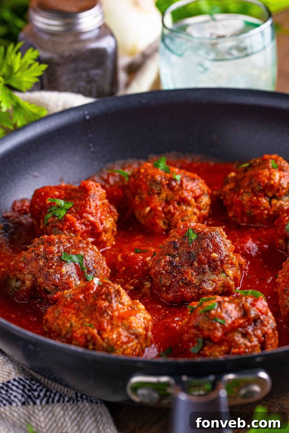Classic Italian Meatballs in a black skillet on the table 