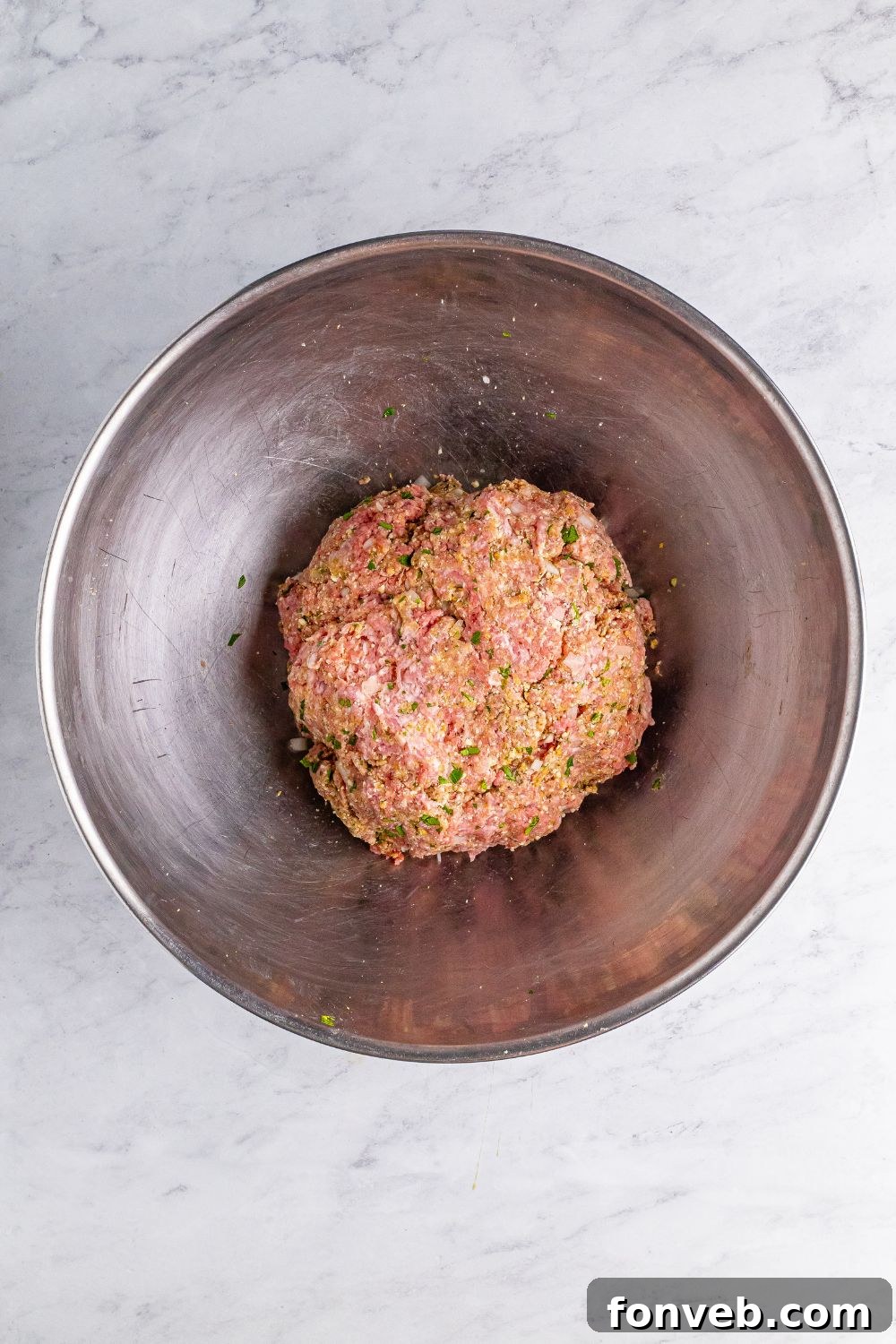 raw meatball mixture in a metal bowl 