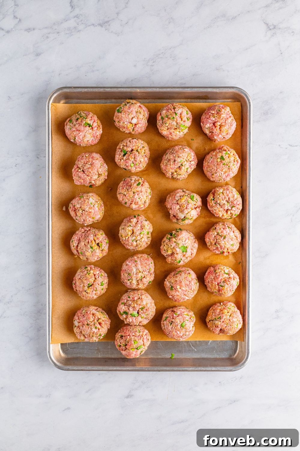 raw Classic Italian Meatballs on a baking tray 