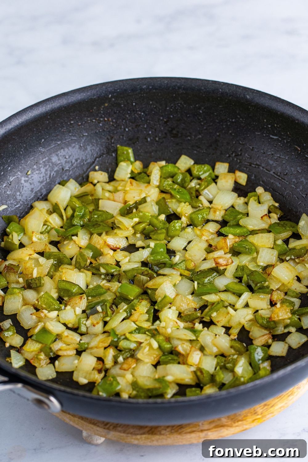 sauted onions and peppers in a skillet on table for Dr. Pepper Sloppy Joes