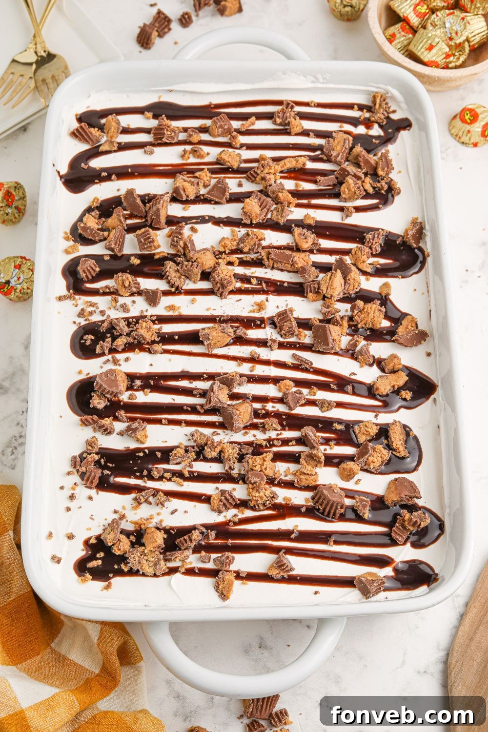 Peanut Butter Chocolate Sweet Stack 14 overhead Reeses Lasagna in a baking dish on table with candies scattered around