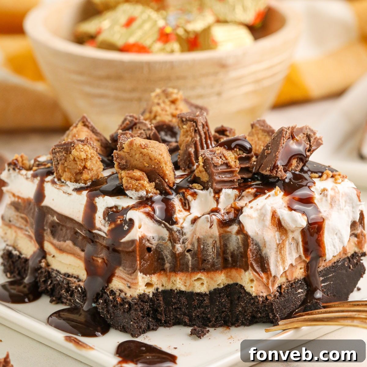 Peanut Butter Chocolate Sweet Stack 3 Reeses Lasagna on a plate with one bite taken out of it
