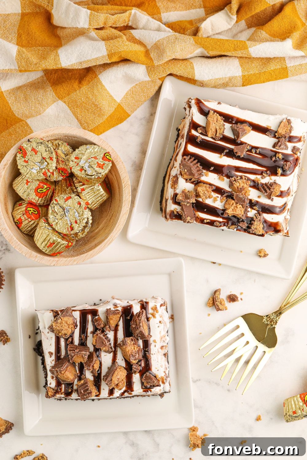 Peanut Butter Chocolate Sweet Stack 21 table with slices of Reeses Lasagna on them and bowl of candy and forks around plates