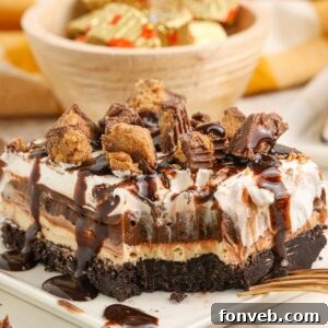 Peanut Butter Chocolate Sweet Stack 22 Reeses Lasagna on a plate with one bite taken out of it