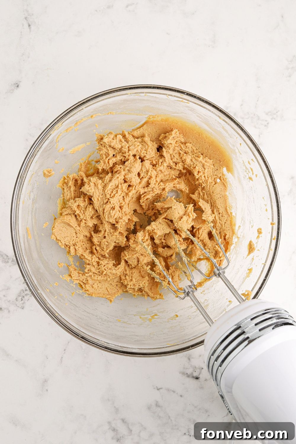 Peanut Butter Chocolate Sweet Stack 7 glass bowl with peanut butter mixture being mixed up for the Reeses Lasagna